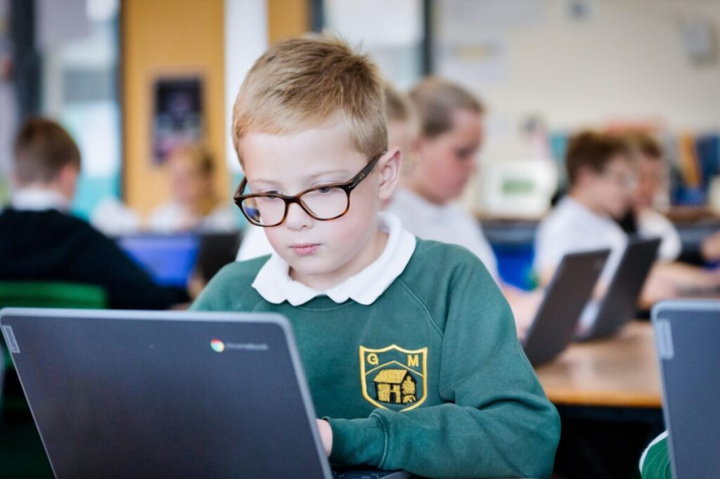 A picture of a student at a Hales Valley Trust school, working on a laptop in a classroom.