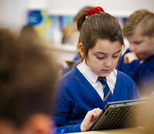A picture of a student at a Hales Valley Trust school, working on a tablet in a classroom.